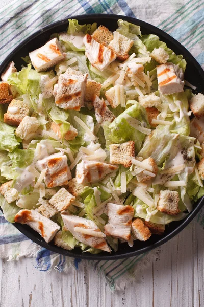Caesar salad with chicken closeup vertical top view — Stock Photo, Image