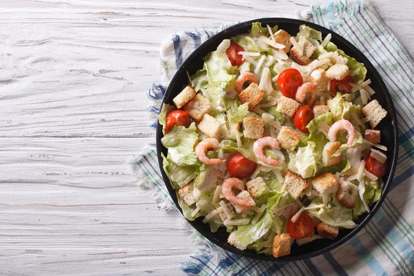 Caesar salad with shrimps horizontal top view — Stock Image Caesar salad with shrimps horizontal top view Stock Photo