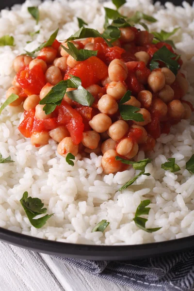 Rice with chickpea curry and herbs closeup vertical — Stock Photo, Image