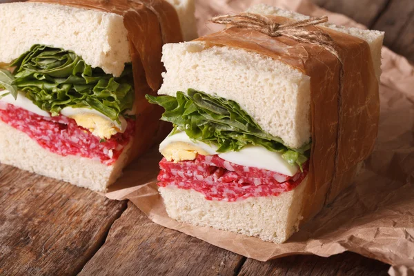 Rustic sandwiches with salami, lettuce and eggs horizontal — Stock Photo, Image