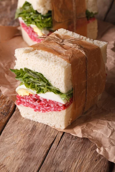 Rustic sandwiches with salami, salad and eggs close-up — Stock Photo, Image