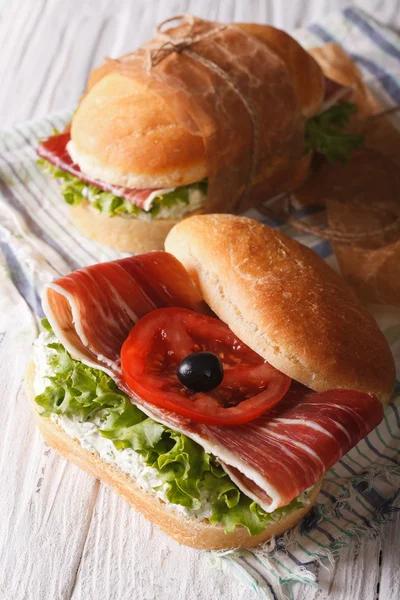 Sandwiches with jamon, cheese and vegetables closeup vertical — Stock Photo, Image