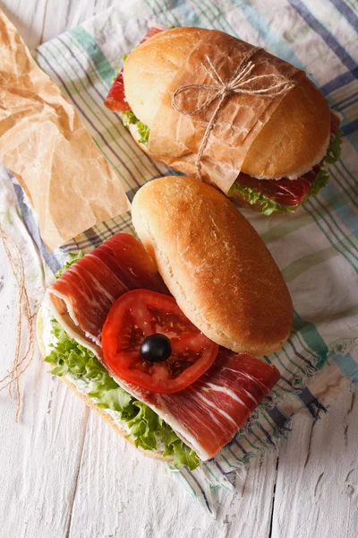 Sandwiches with prosciutto and vegetables vertical top view — Stock Photo, Image