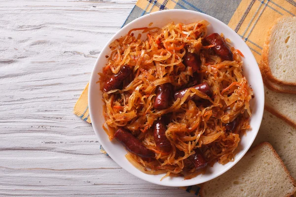 Stewed cabbage with sausages horizontal top view — Stock Image Stewed cabbage with sausages horizontal top view Stock Photo