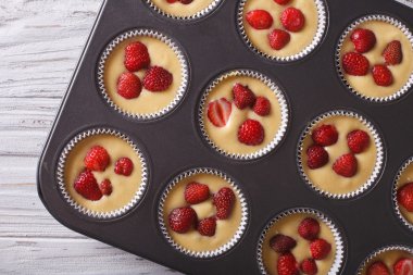 cooking strawberry muffins in baking dish top view horizontal