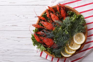 crayfish with herbs and lemon on a plate. Horizontal top view  clipart