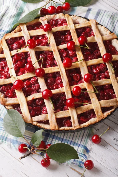Homemade cherry pie close-up on the table. vertical top view — Stock Photo, Image
