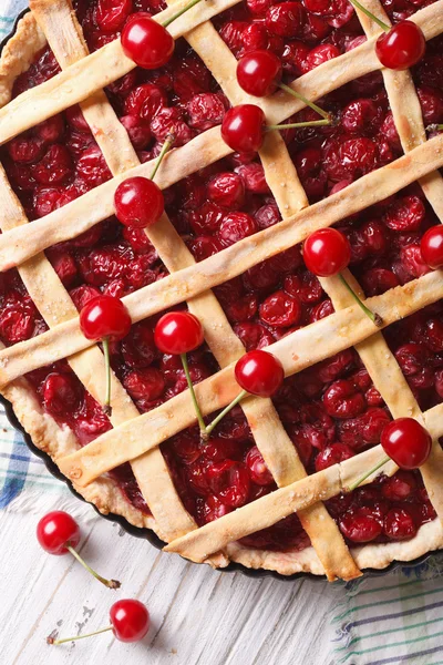 Cherry pie close up on the table. vertical top view — Stock Photo, Image