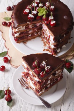 Sliced cherry cake with chocolate close-up. vertical top view