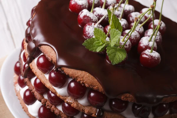Cake with fresh cherries and chocolate on the plate closeup — Stock Photo, Image