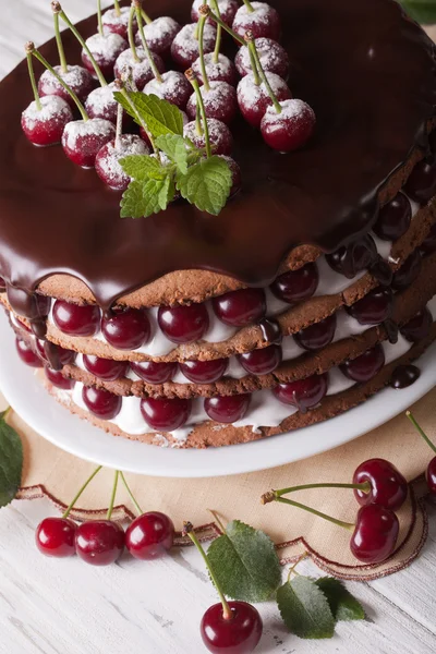 Cherry cake with chocolate and cream close-up vertical — Stock Photo, Image