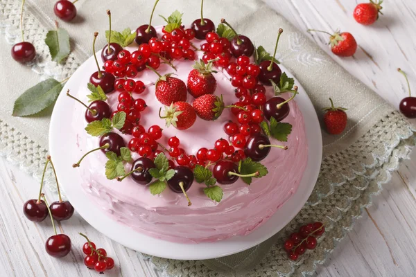 pink cake with fresh berries on a plate close-up. horizontal