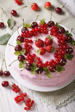 Beautiful pink berry cake on a plate closeup. vertical top view