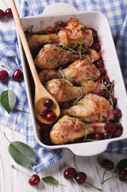 Baked chicken legs in cherry sauce and rosemary vertical