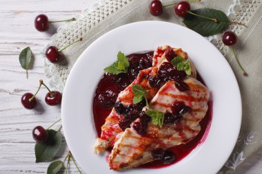 Grilled chicken with cherry sauce close up. horizontal top view