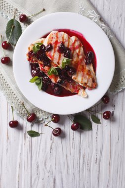 Grilled chicken with cherry sauce and mint. vertical top view