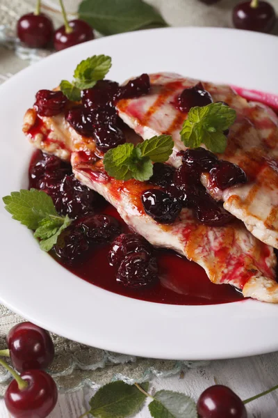 Grilled chicken with cherry sauce on a plate close-up. Vertical — Stock Photo, Image