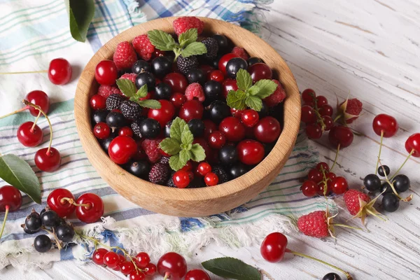 Berry mix in a wooden bowl close-up. Horizontal — Stock Photo, Image