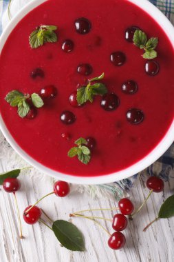 cold cherry soup in a bowl on a table close-up. vertical top vie