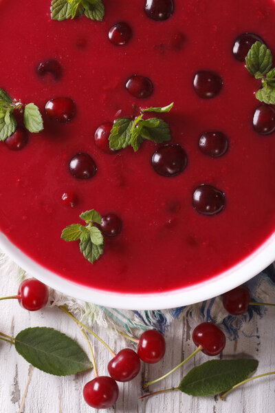 delicious cold cherry soup in a bowl macro. vertical top view