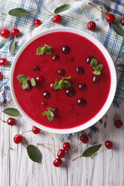 Cherry cream soup with mint close-up. vertical top view — Stock Image Cherry cream soup with mint close-up. vertical top view Royalty Free Stock Photos