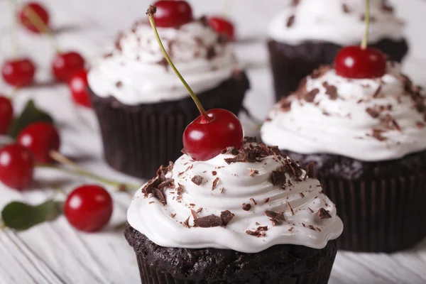 Chocolate cupcakes with white cream and cherry, horizontal macro — Stock Photo, Image