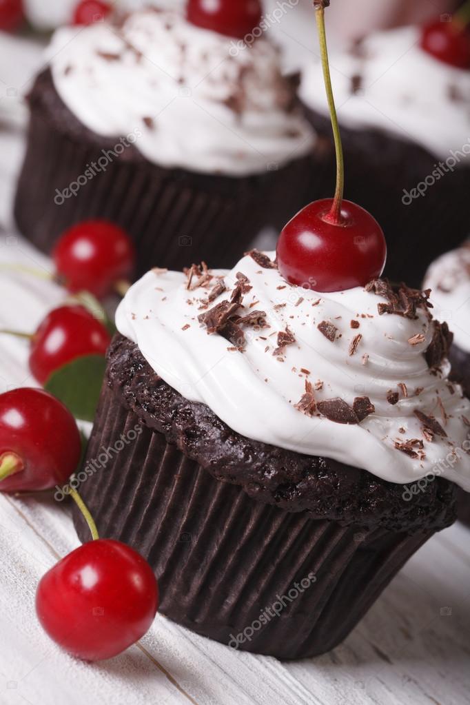delicious chocolate cupcakes with cherry close up, vertical