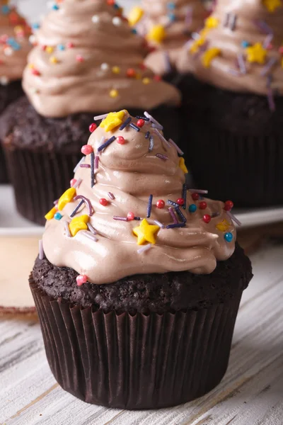 Schokolade Cupcakes mit Sahne und Bonbons Streusel vertikal — Stockfoto