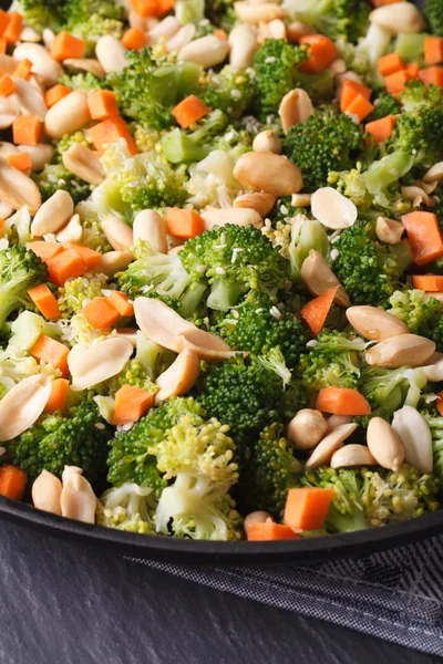 Beautiful salad of broccoli with peanut on a plate macro. vertic — Stock Photo, Image