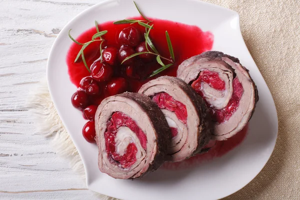 Meat roll stuffed with cherries close-up horizontal top view — Stock Photo, Image