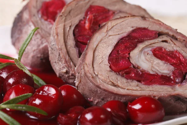 Meat roll with cherries macro on a plate. Horizontal — Stock Photo, Image