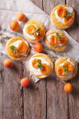 Homemade apricot biscuits white cream and mint vertical top view