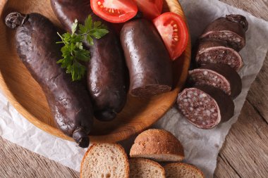 blood sausage with tomato on a plate close-up. horizontal top vi