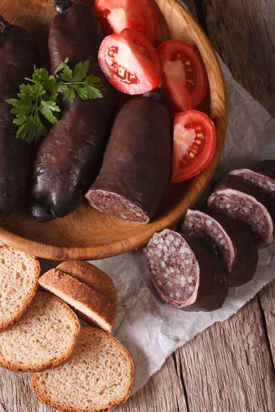 Fresh black pudding on a plate close-up. vertical top view — Zdjęcie stockowe