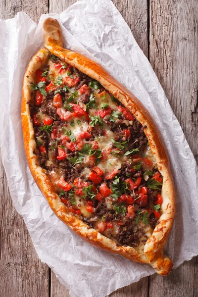 Hot pizza Turkish pide close up on the table. vertical top view — Stock Fotó