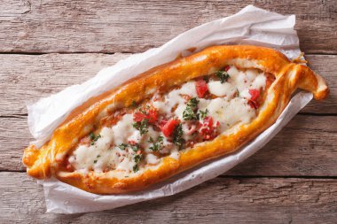 Hot Turkish pide pizza closeup on a table. horizontal top view