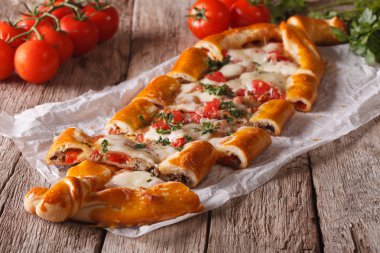 Sliced Turkish pide close up on the table and ingredients. Horiz