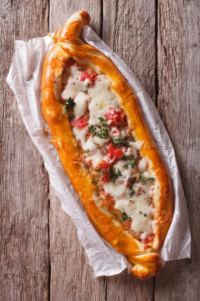 Hot Turkish pide pizza closeup on a table. vertical top view — Stockfoto