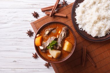 Thai beef massaman curry and rice side dish. horizontal top view