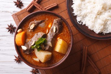 Thai beef massaman curry and rice side dish closeup. horizontal 