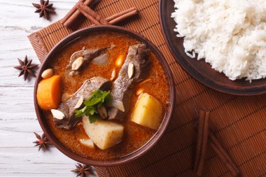 Thai beef massaman curry and rice side dish closeup. horizontal  clipart
