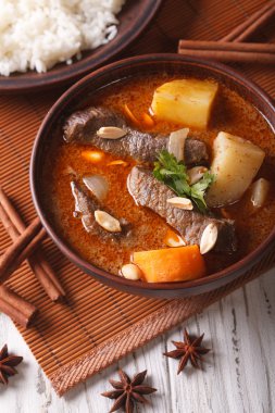 Thai beef massaman curry with peanuts close-up. vertical