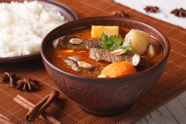 Thai beef massaman curry with peanuts close-up. Horizontal clipart