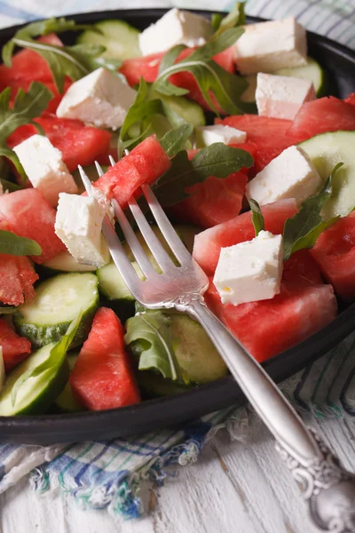 Salad of watermelon, feta, arugula and cucumbers closeup. Vertic — Stock Photo, Image