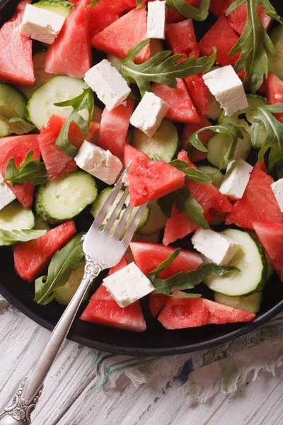 Salad of watermelon, cheese, arugula and cucumbers closeup. Vert — Stock Photo, Image