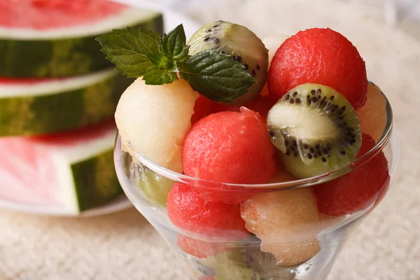 Fruit balls of watermelon, kiwi and melon in a glass close up ho — Stock Photo, Image