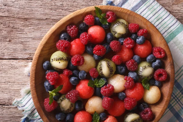 Salad of fresh fruits and berries closeup. horizontal top view — Stock Photo, Image