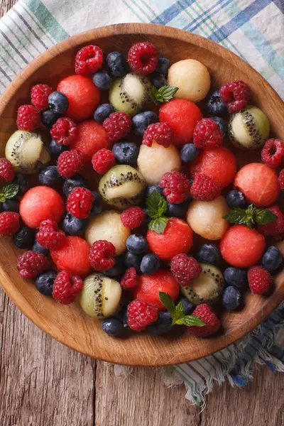 Salad of fresh fruits and berries closeup. vertical top view — Stock Photo, Image