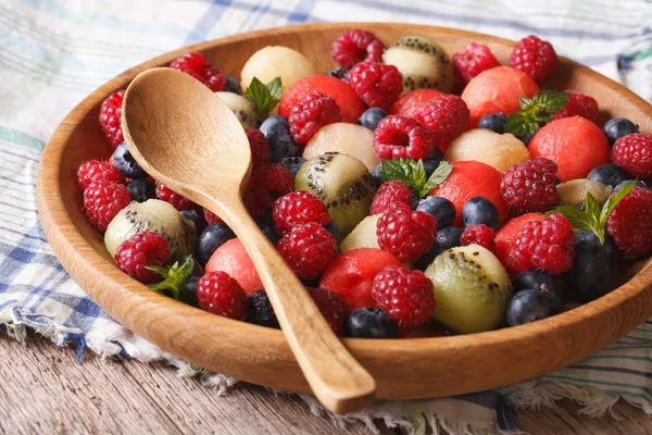 Salad of blueberries, watermelon, raspberry, melon and kiwi in — Stock Photo, Image