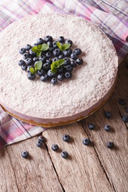 cheesecake with blueberries and mint close-up. Vertical